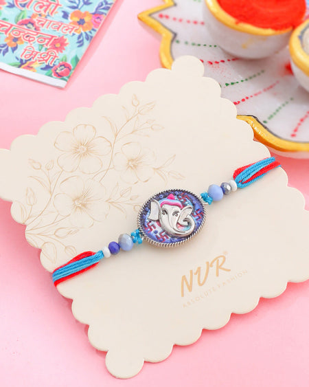 NVR Men Red & Blue Ganesh Ji Thread Rakhi with Roli Chawal Chandan & Mishri