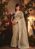 Monjolika Fashion Designer Beige Tissue Organza Saree With All Over Butta Work & Heavy Stone Embellished Border - Distacart
