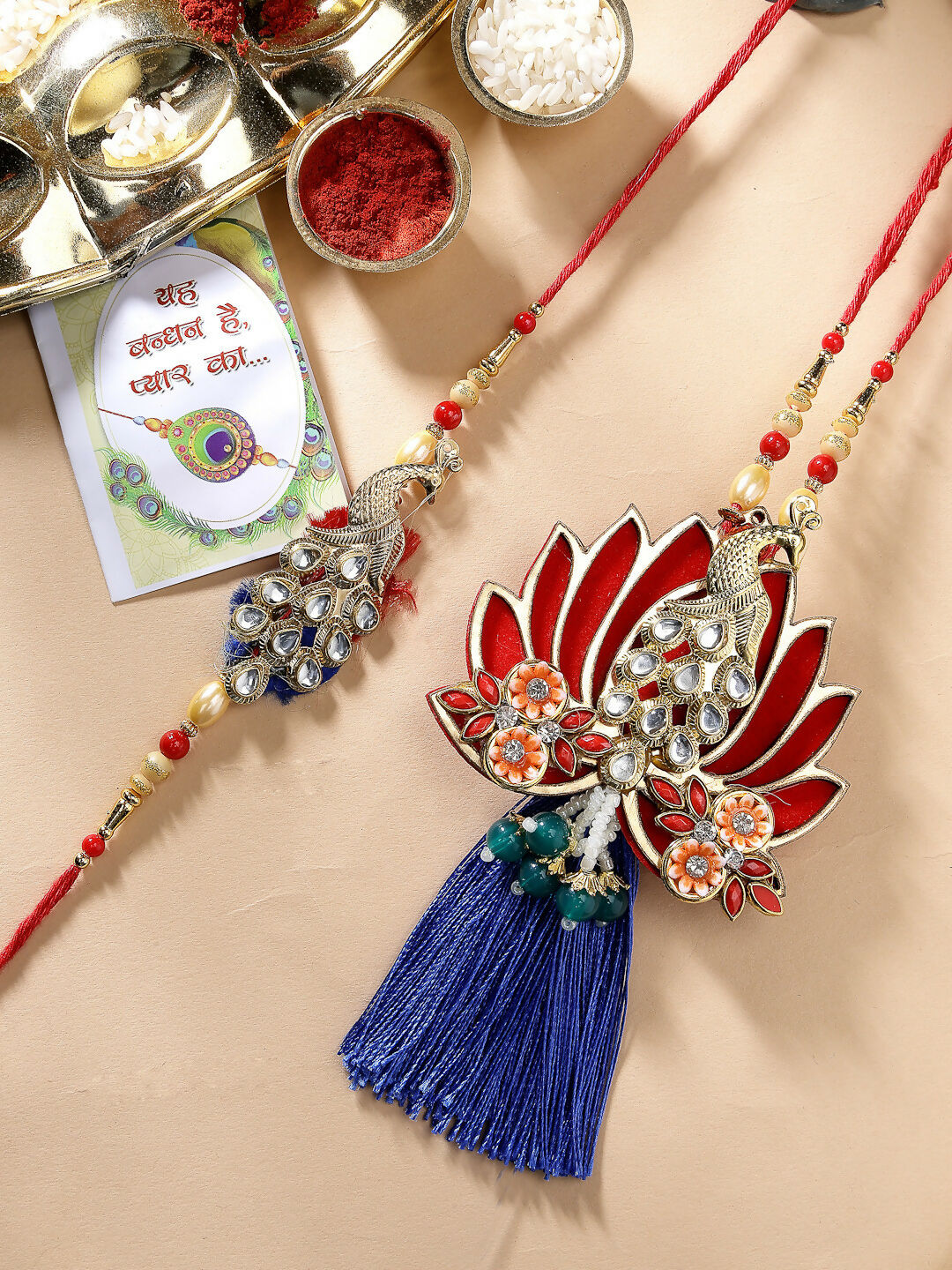 NVR Women & Men Set of 2 Gold-Toned Peacock Design Stone-Studded Bhaiya Bhabhi Rakhi With Roli Chawal & Chocolate - Distacart