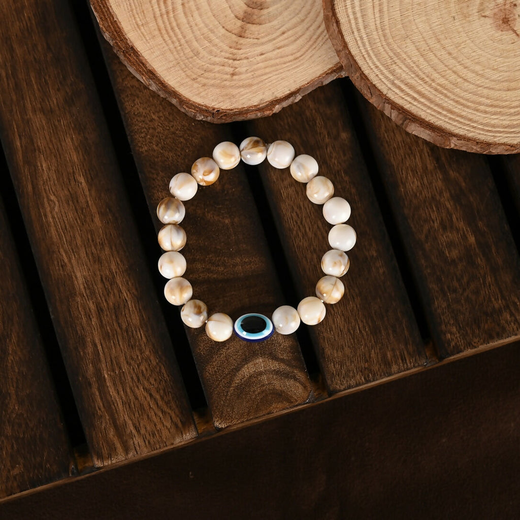 NVR Women & Men Cream-colored Evil Eye Elasticated Rakhi With Roli Chawal - Distacart