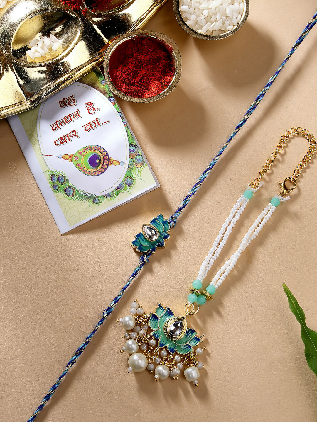 NVR Women & Men Set of 2 Turquoise Blue Lotus Shape Kundan-Studded & Beaded Handcrafted Wraparound Rakhi Set With Roli Chawal - Distacart