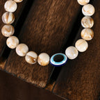 NVR Women & Men Cream-colored Evil Eye Elasticated Rakhi With Roli Chawal - Distacart