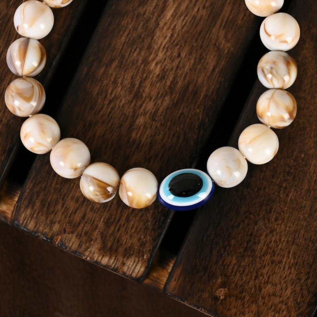 NVR Women & Men Cream-colored Evil Eye Elasticated Rakhi With Roli Chawal - Distacart