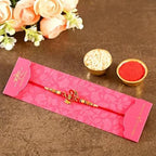 Auspicious Om Pearl Rakhi & Cadbury Fruit N Nut