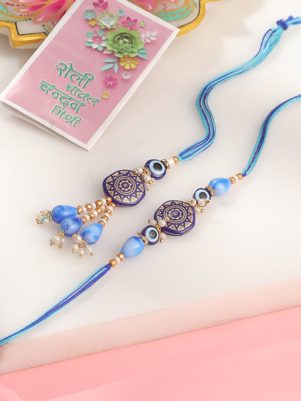 NVR Evil Eye Set of 2 Blue Artificial Beads Bhaiya Bhabhi Rakhi with Roli Chawal Chandan & Mishri - Distacart