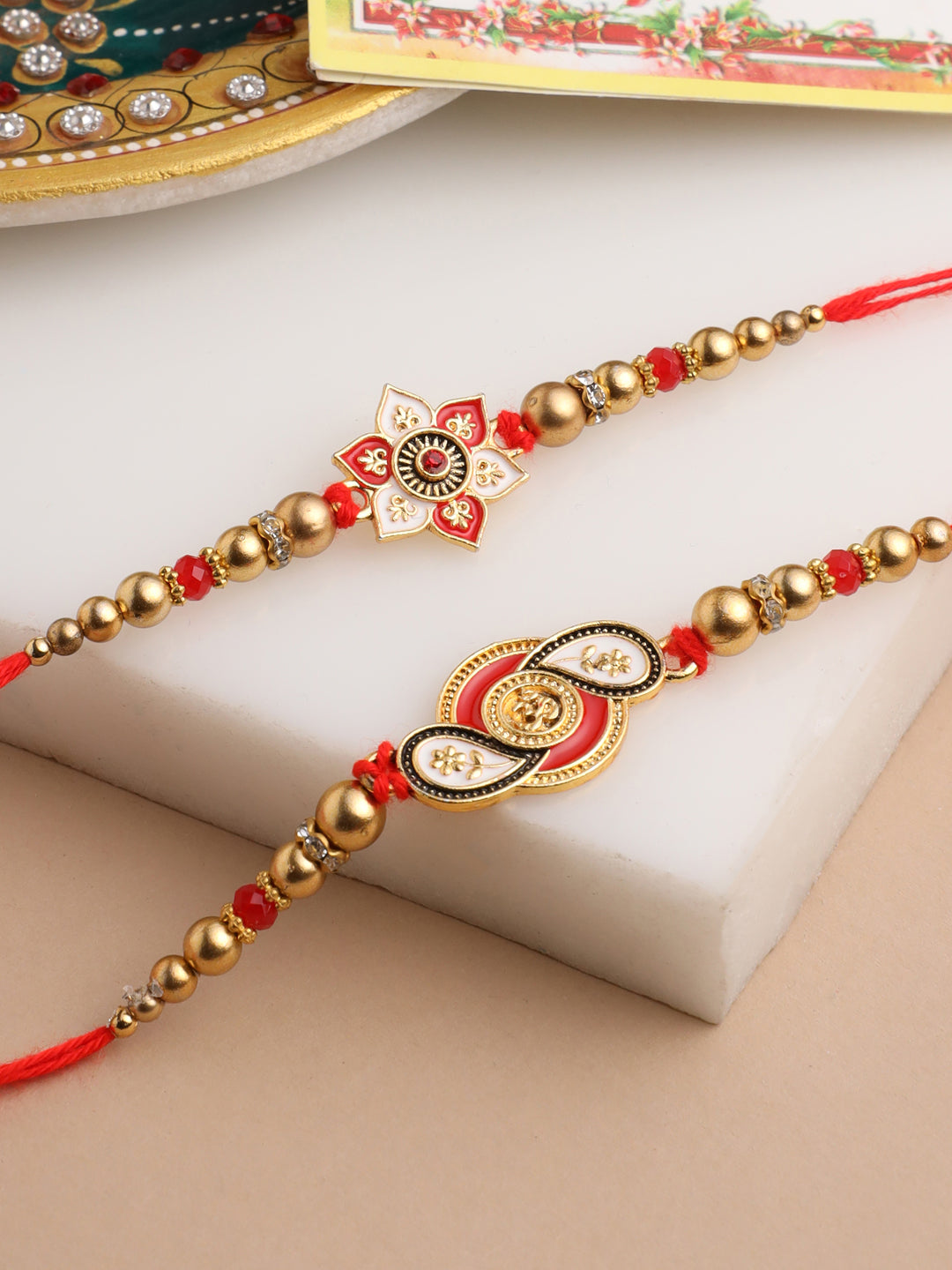 NVR Men Set of 2 Red & Gold Floral Design Artificial Beads Thread Rakhi With Roli Chawal Chandan & Mishri - Distacart
