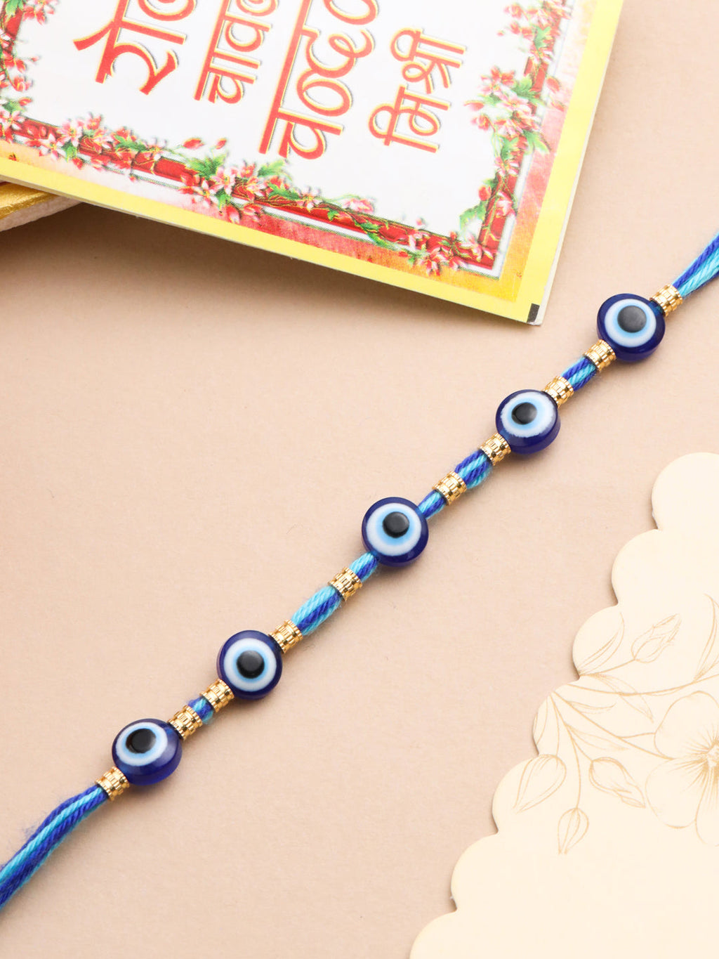 NVR Men's Blue Evil Eye Thread Rakhi with Roli Chawal Chandan & Mishri - Distacart