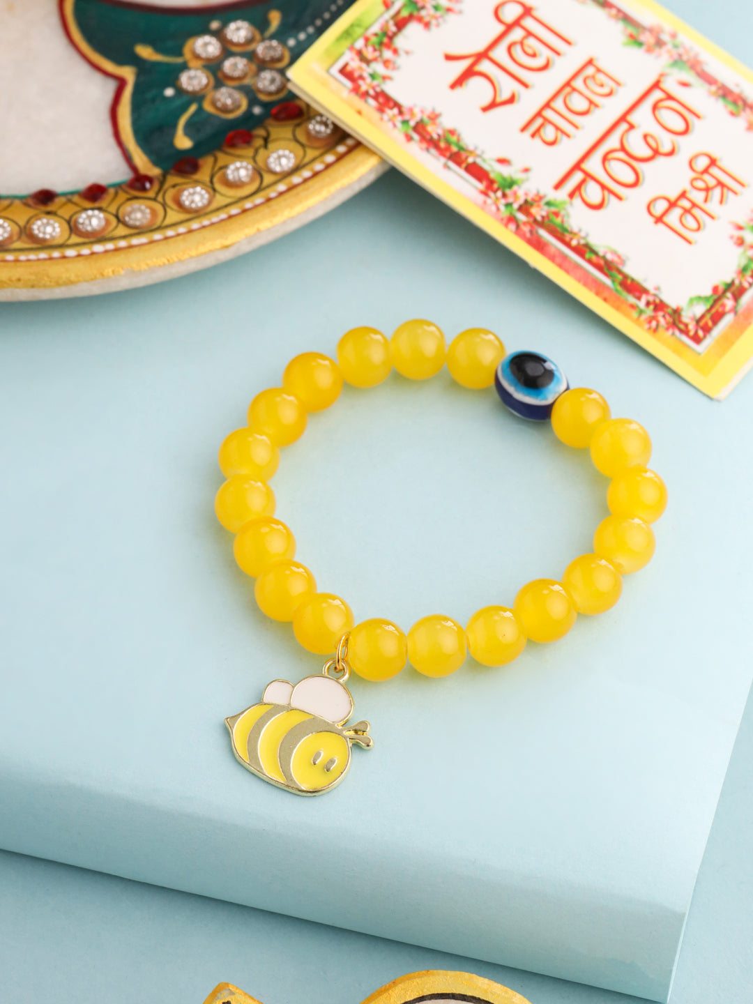 NVR Kids Cartoon Design Yellow Artificial Beads Thread Rakhi with Roli Chawal Chandan & Mishri - Distacart