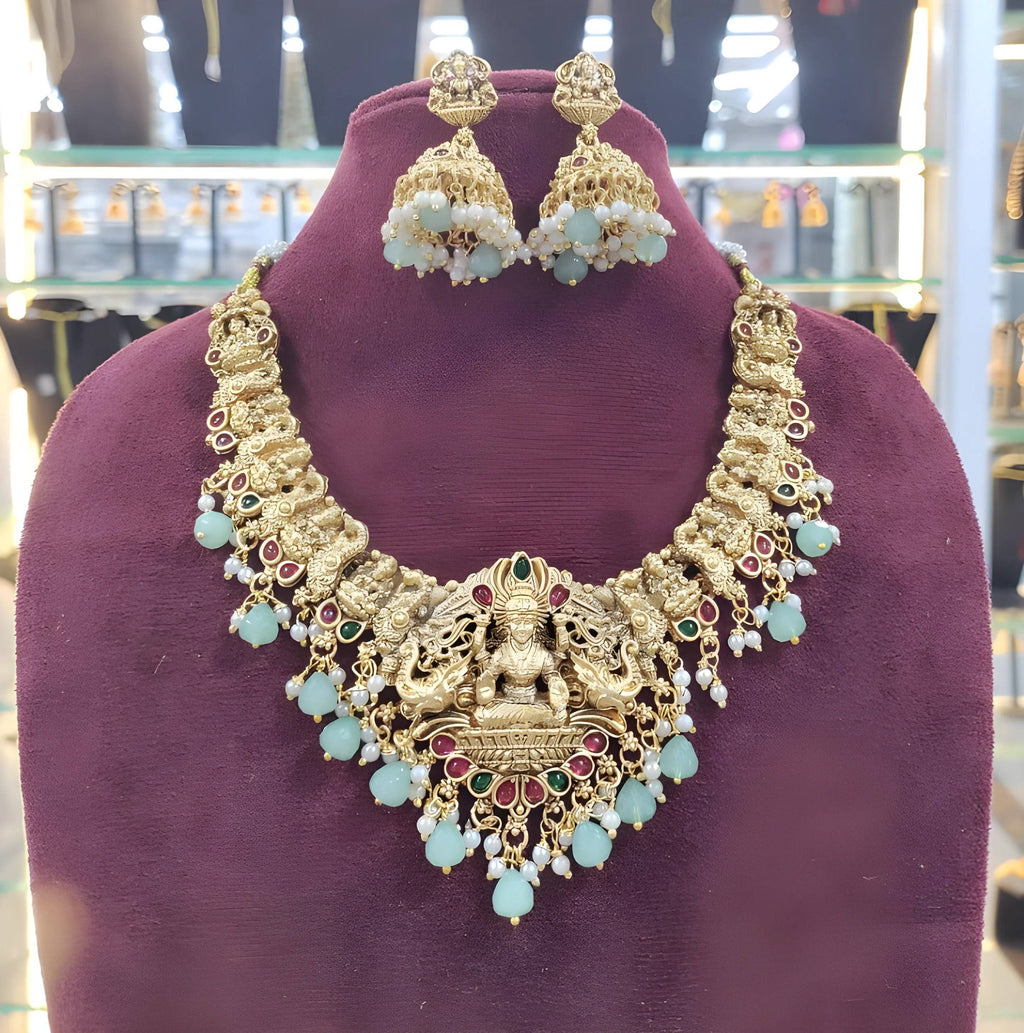 Jewel City Opulent Gold Peacock Lakshmi Temple Necklace Set - Handcrafted Antique Finish Bridal Jewelry with Emerald & Pearl Accent