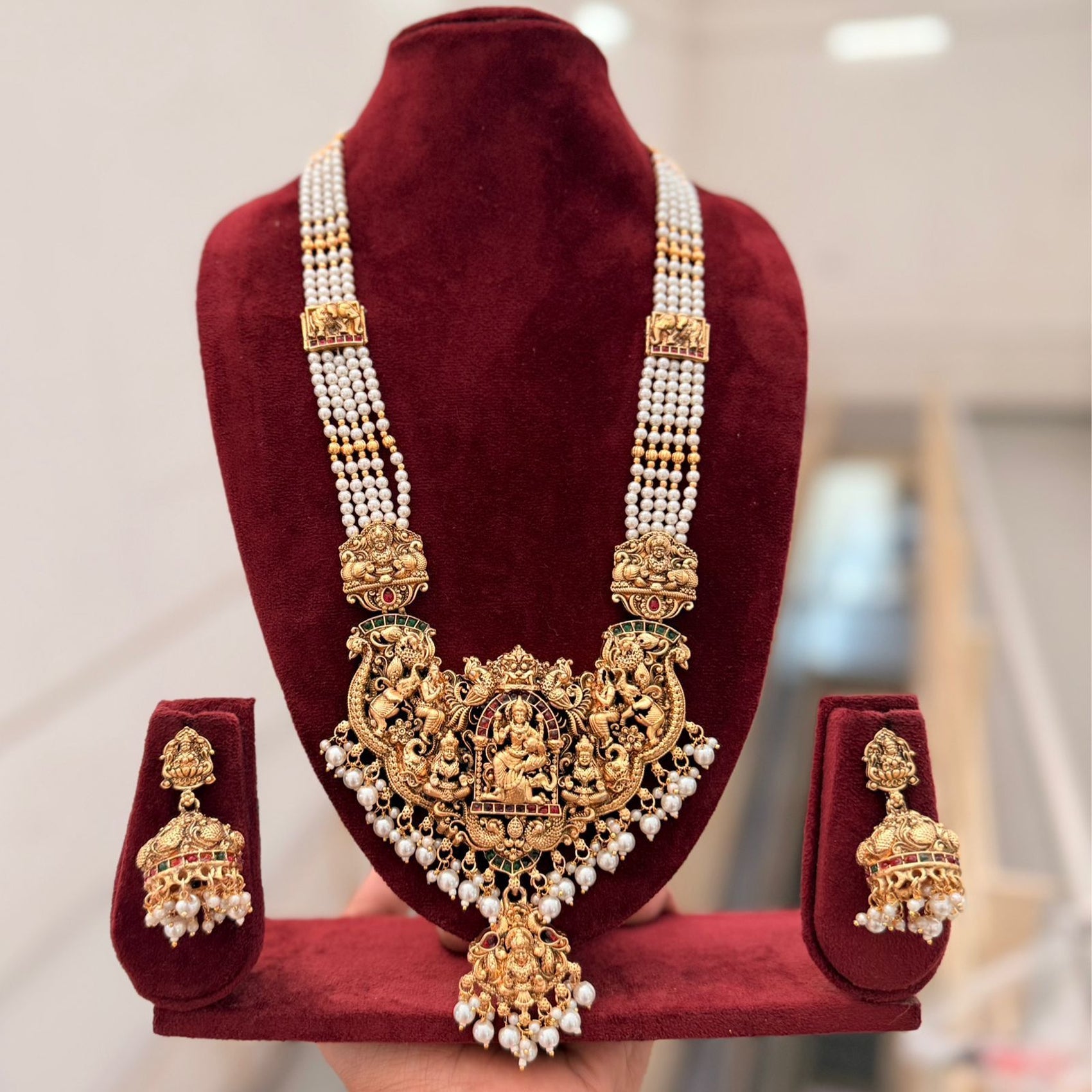 Jewel City Antique Gold-Plated Temple Lakshmi Haram Necklace Set with White Beads & Jhumka Earrings