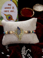 NVR Men Gold-Toned Peacock Design Stone-Studdded Rakhi With Roli Chawal & Chocolate - Distacart