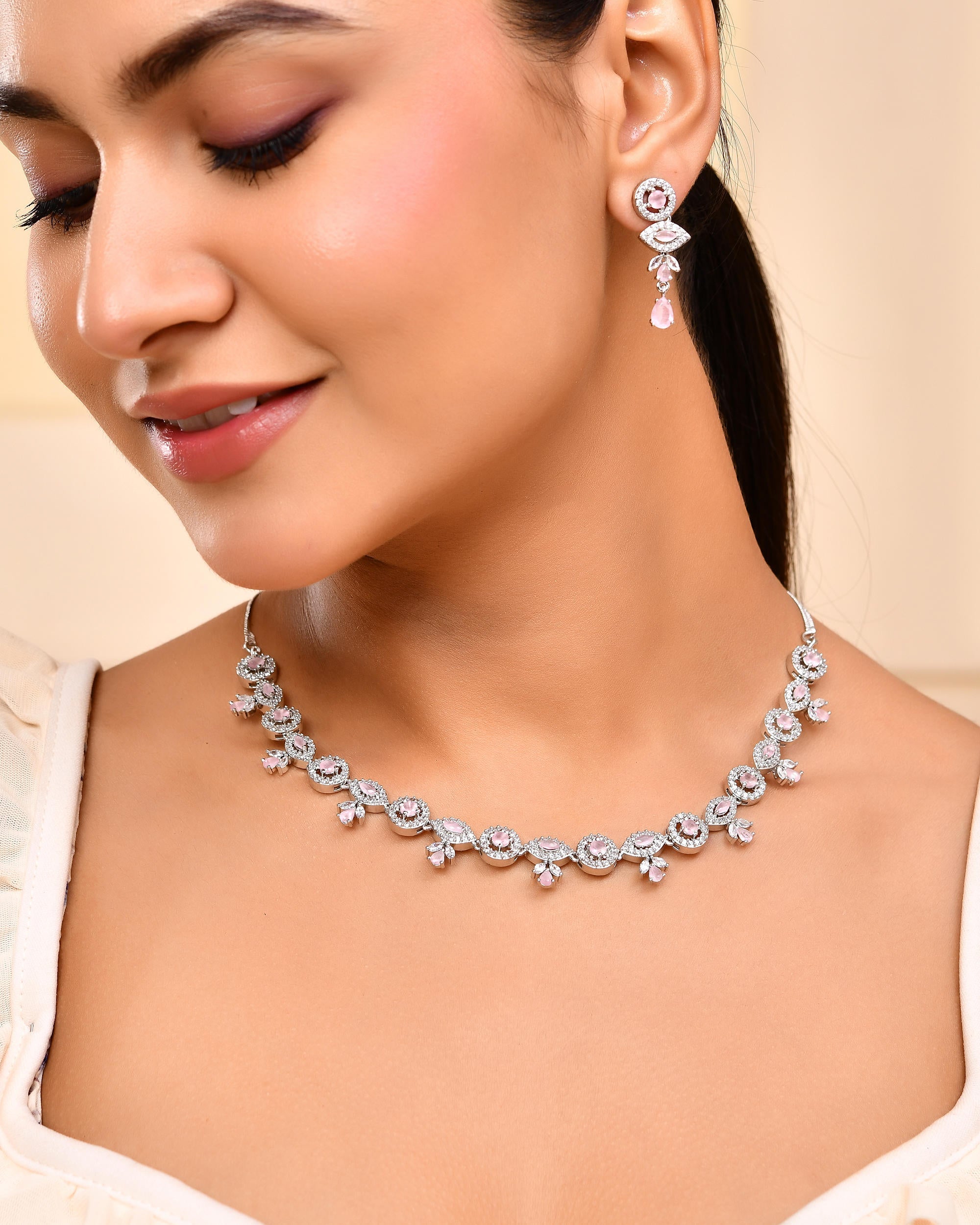 VOJ Silver Toned White And Baby Pink Stone Studded AD Jewellery Set