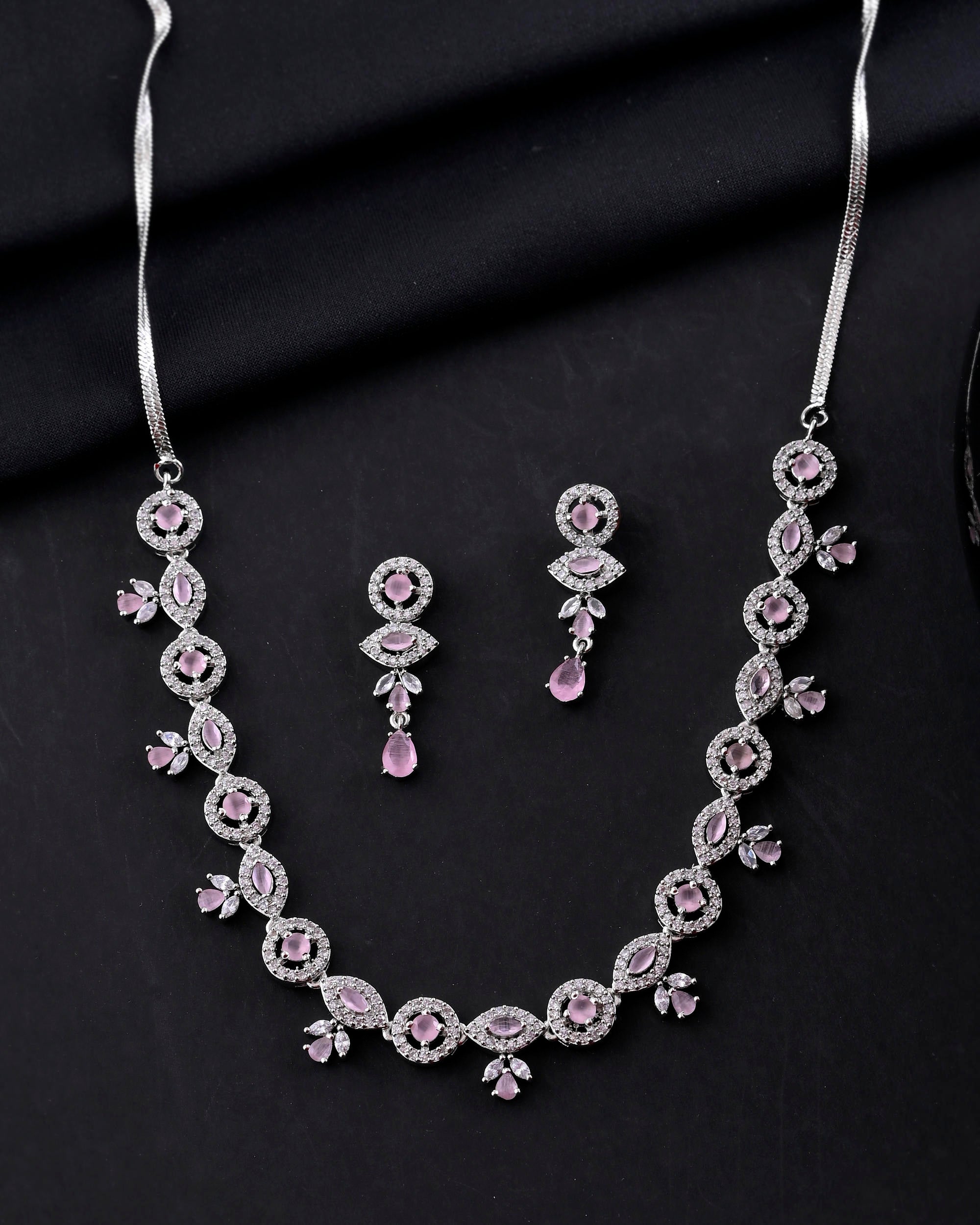 VOJ Silver Toned White And Baby Pink Stone Studded AD Jewellery Set