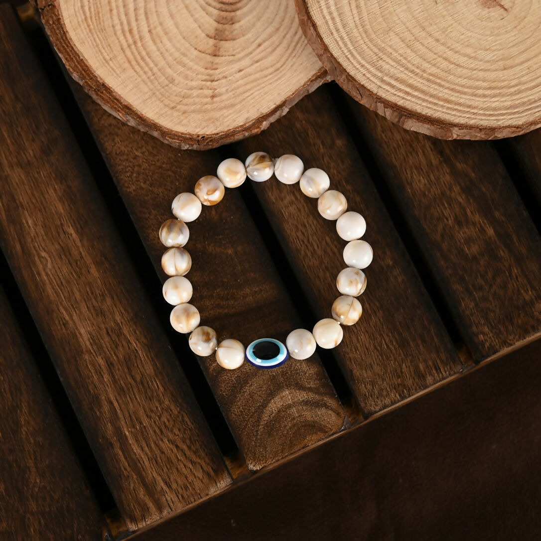 NVR Women & Men Cream-colored Evil Eye Elasticated Rakhi With Roli Chawal - Distacart