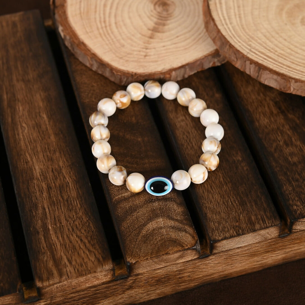 NVR Women & Men Cream-colored Evil Eye Elasticated Rakhi With Roli Chawal - Distacart